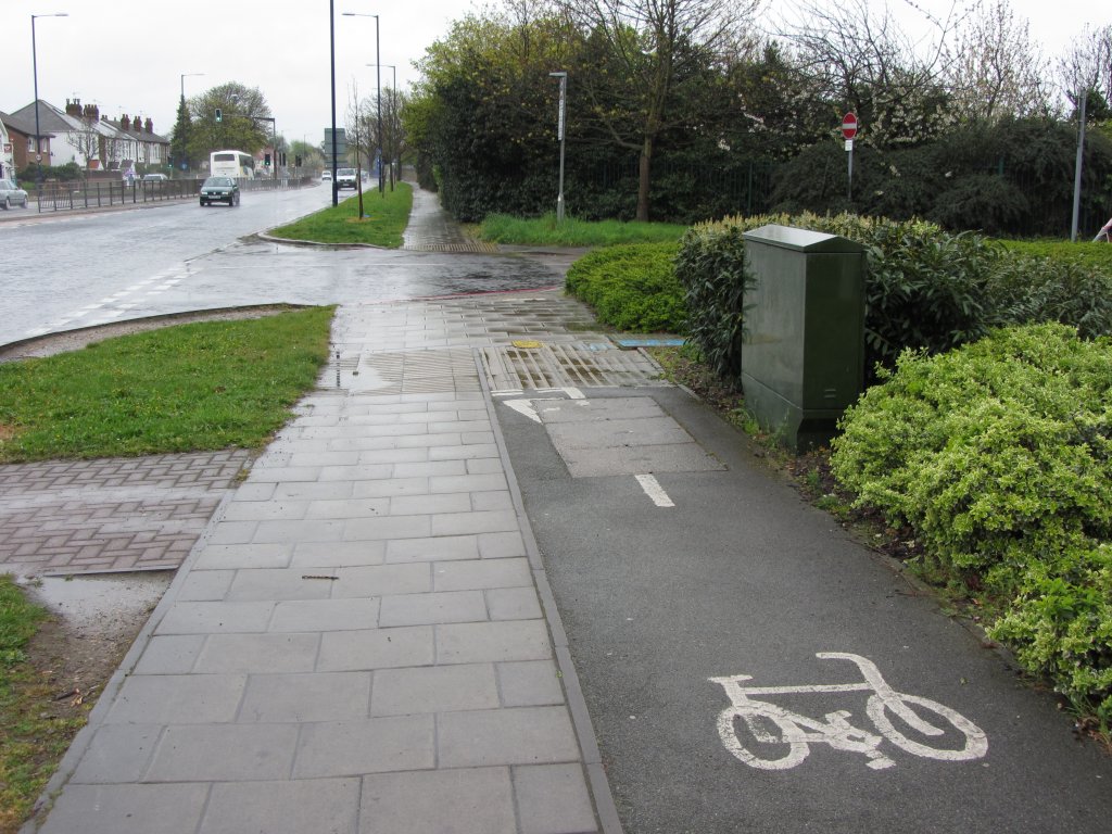 Spurrillen auf Radwegen - in England sind die mittig im Bild zu sehenden Markierungs-Steine oft längs zur Fahrtrichtung angebracht. Bei Glätte besteht sehr hohe Sturzgefahr. Eine Benutzungspflicht besteht in England nicht. London, Hounslow, April 2012