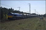 HHPI 561-01 / 266 038-9 fuhr mit einem Schotterzug am 16.04.2019 durch die Berliner Wuhlheide.